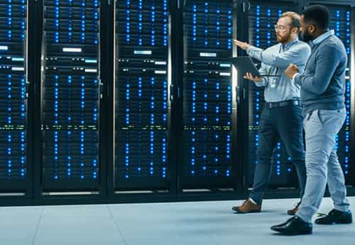 colleagues walk through a data center while discussing the role of data and technology in commercial real estate